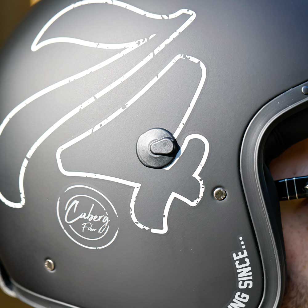 closeup of 74 logo design on side of matte black helmet