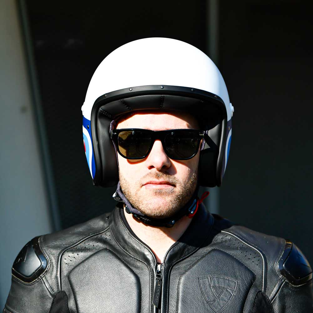 front of biker wearing matte white open face biker helmet with black tinted sunglasses
