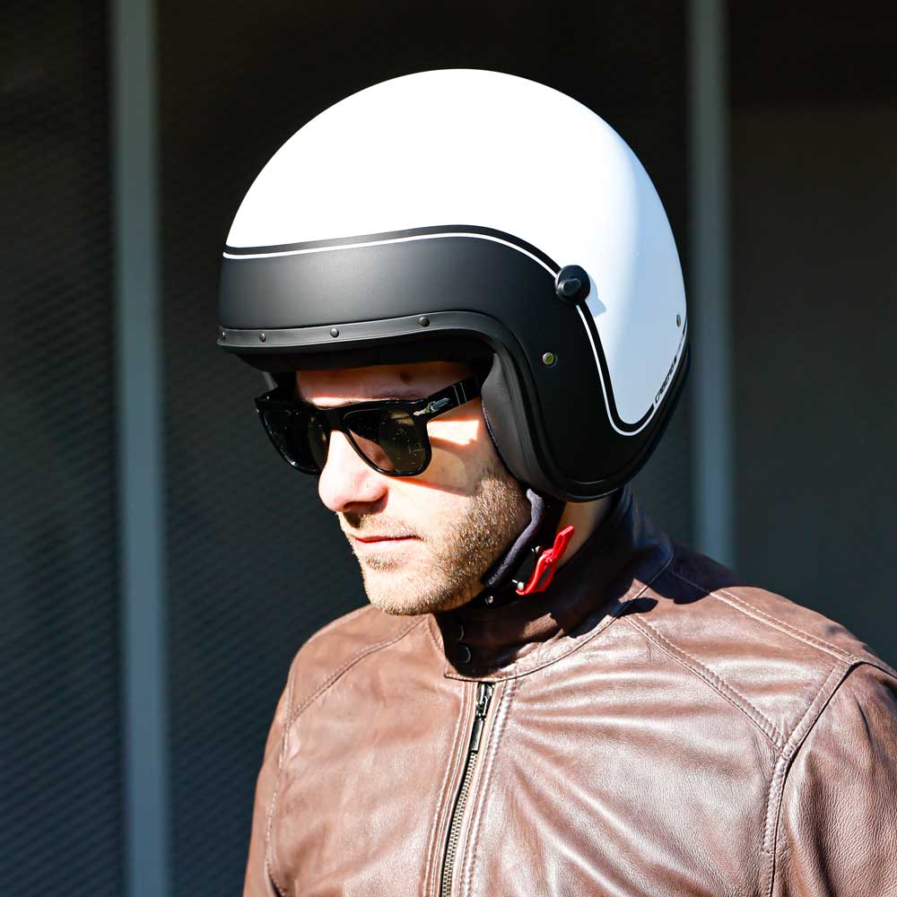 biker wearing black and white open face biker helmet with shades