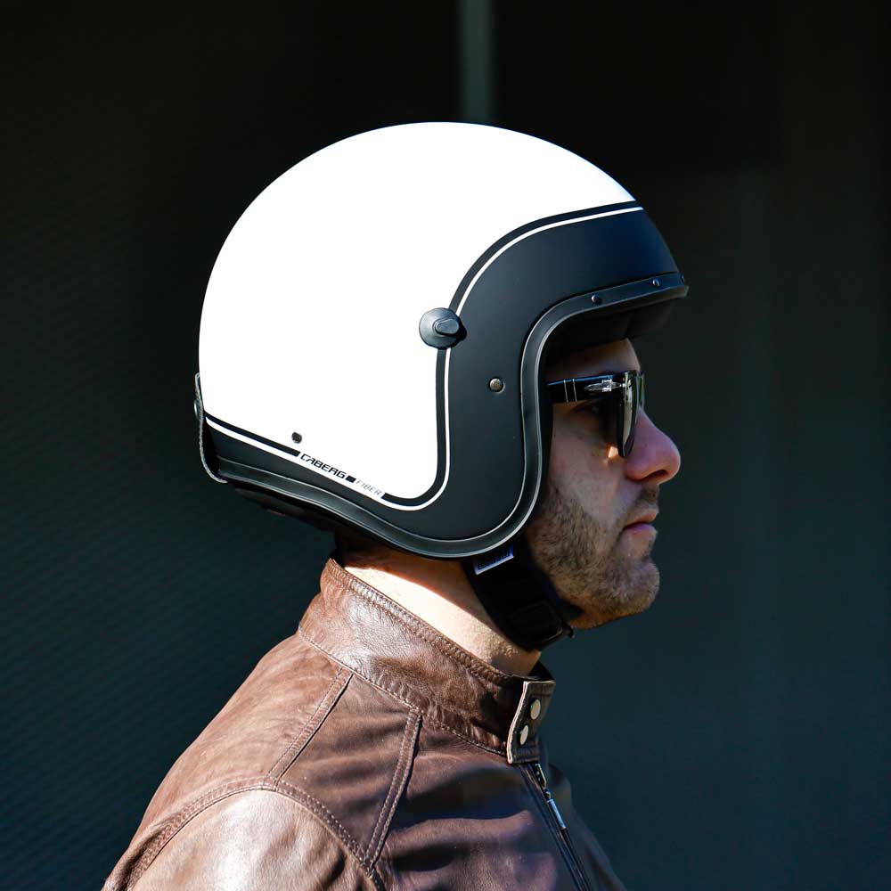 side view of biker wearing black and white open face motorbike helmet with sunglasses