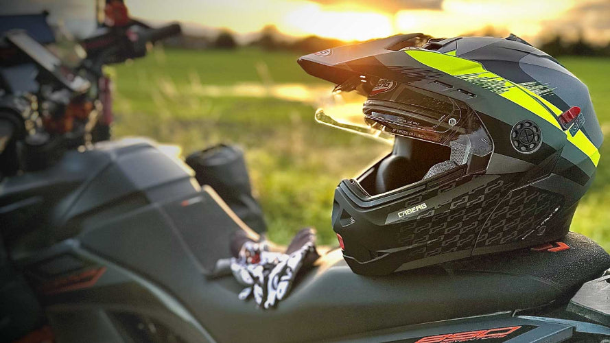 black and yellow flip up tourmax x caberg motorbike helmet sitting on a motorbike in the sunset