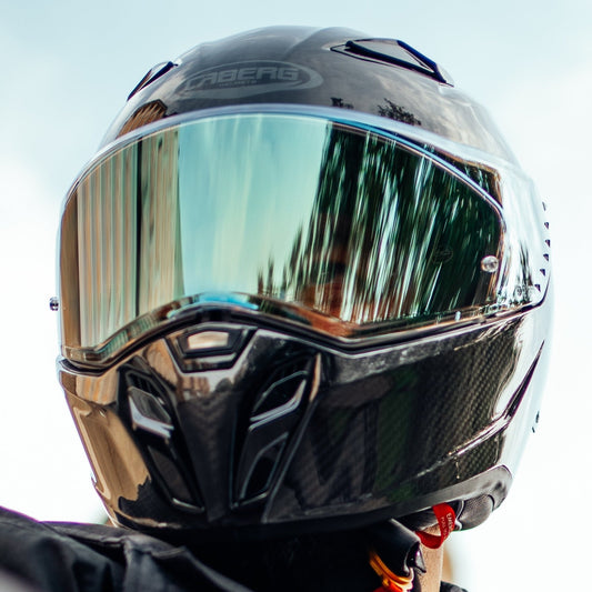 biker wearing black caberg motorbike helmet with tinted visor
