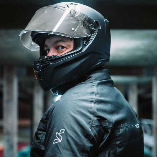 biker wearing black full face motorcycle helmet with visor up