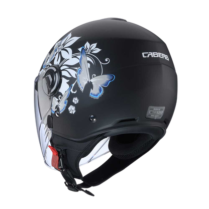 Rear view of the matt black Caberg Riviera V4X Mia helmet, highlighting the white and blue flower pattern and the helmet's contoured rear styling.